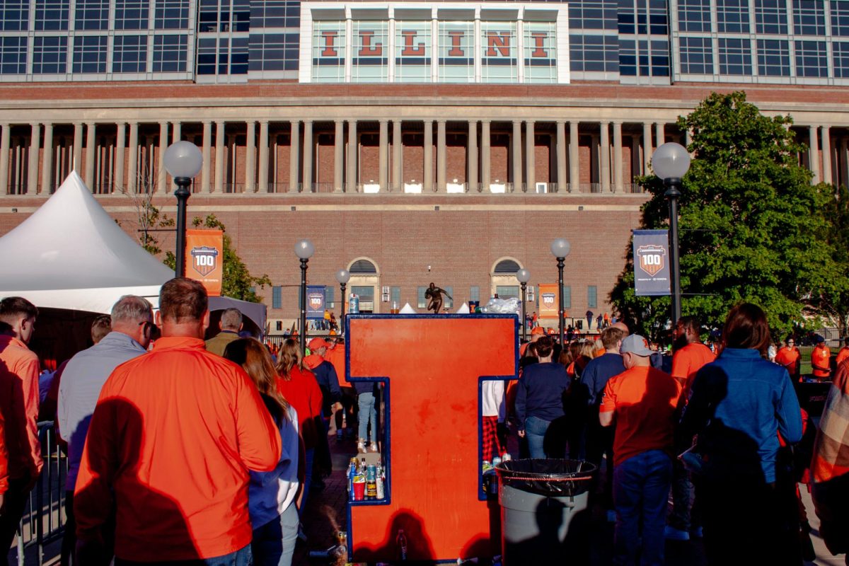 A crowd of Illini flood Grange Grove as they head forward to enter Memorial Stadium on Sept. 7.