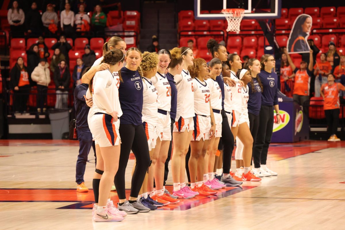 The Illini link arms on the court in a show of unity during a game against Florida State on Feb. 13.