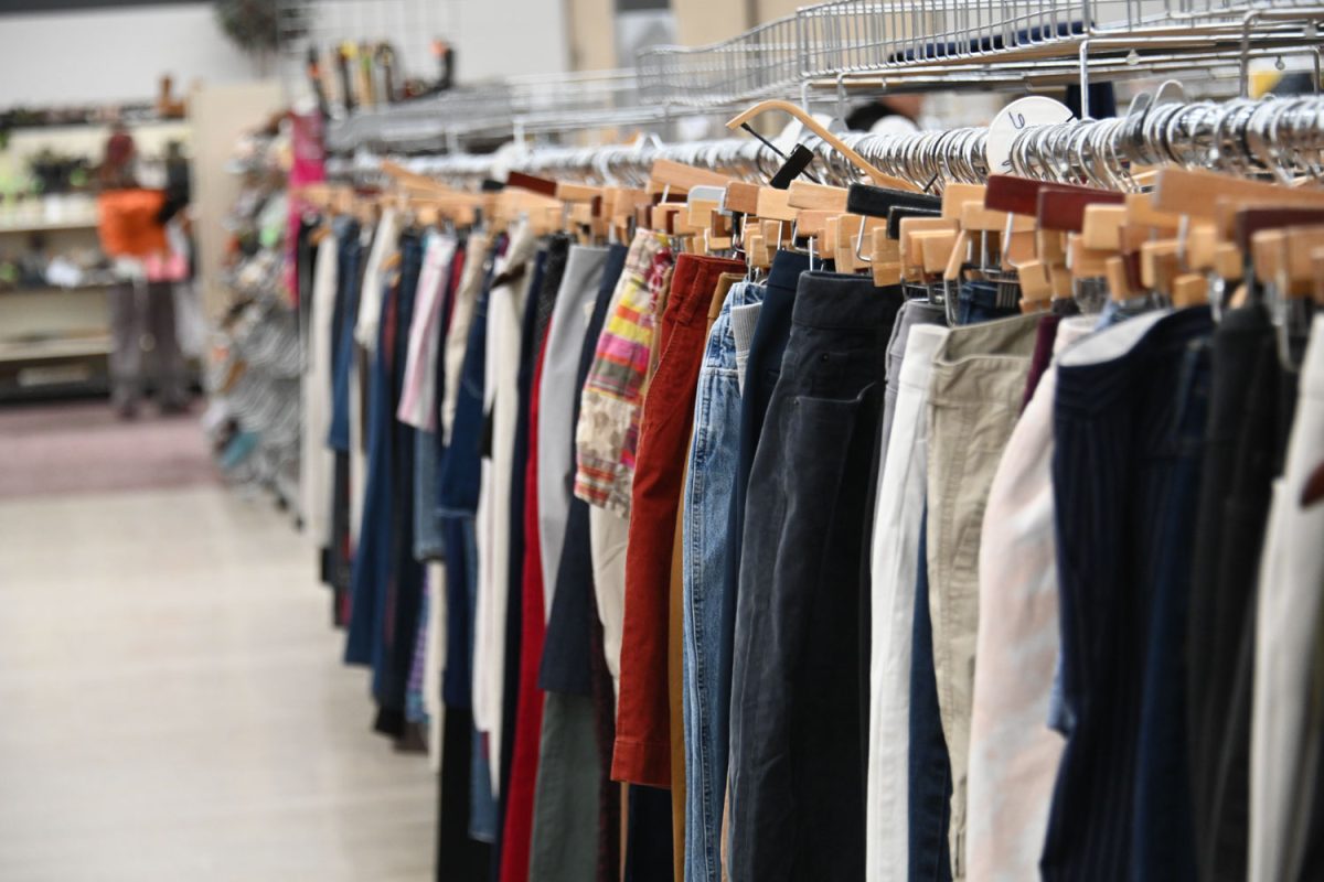 Thrift clothes hangs racks aisles within the aisles of Salt and Light on Feb. 18.