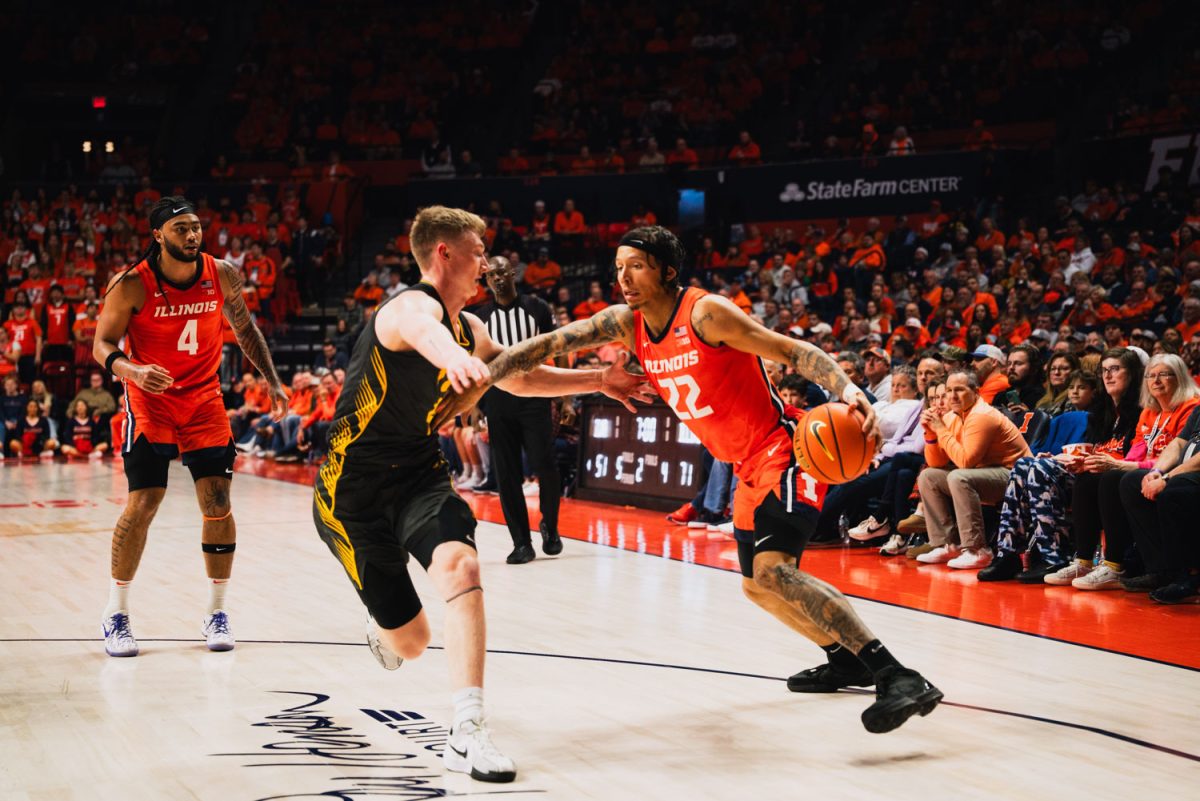 Junior guard Tre White drives to the rim against Iowa’s defense on Feb. 25 at State Farm Center. The Illini won 81-61.