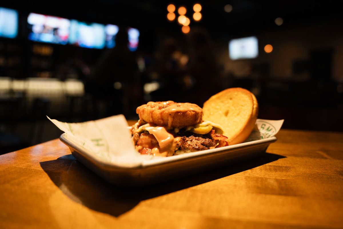 City Slicker burger from Smith Burger Company sits steaming on a table inside their restaurant located on 340 N. Neil Street, Champaign.