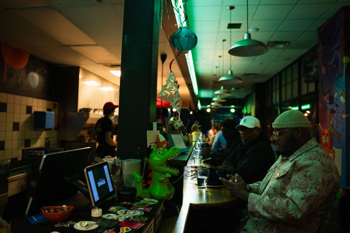 Customers wait for their meals at The Space as stand up comedy takes place in the back on Feb. 28.