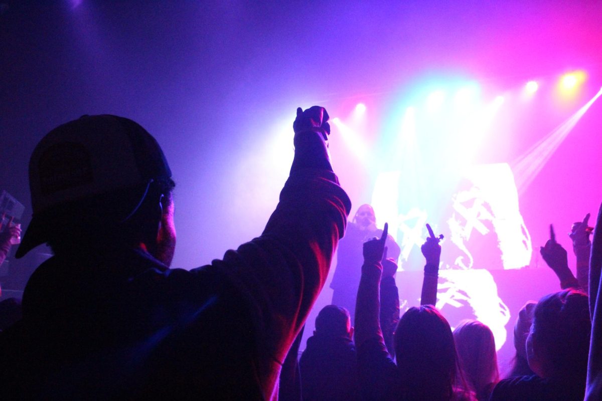 Attendees of Canopy Club raise their arms and join in the air as the jam out to a DJ set on Jan. 29.