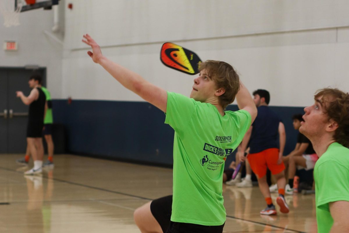 A pickleball team member prepares to hit the ball at the Illini Get Pickled Charity Pickleball Tournament in February 2024.