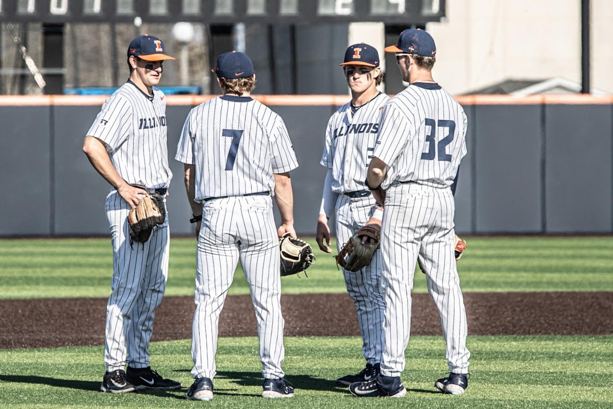 Four players, including junior infielder and pitcher Grant Ross and redshirt sophomore infielder Kyle Schupmann, talk on the infield during a game against Indiana on April 12. 