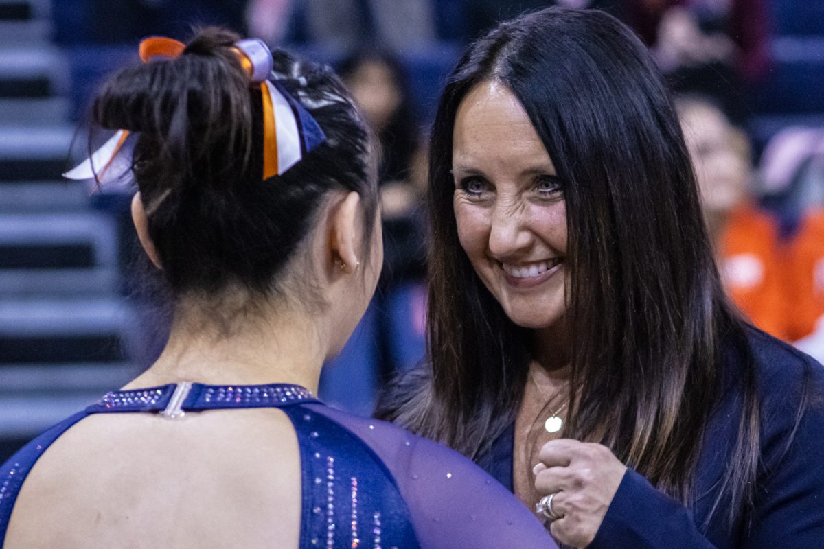 Head coach Nadalie Walsh encourages redshirt sophomore Megan Sapp during a meet against Ohio State Feb. 7. Illinois upset Ohio with a team score of 196.150-195.475.