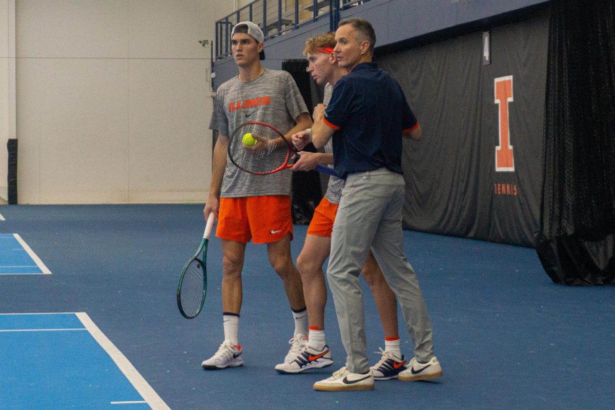 (L-R) Senior Mathis Debru, redshirt junior William Mroz and head coach Brad Dancer huddle during a match against Notre Dame on Feb. 15.