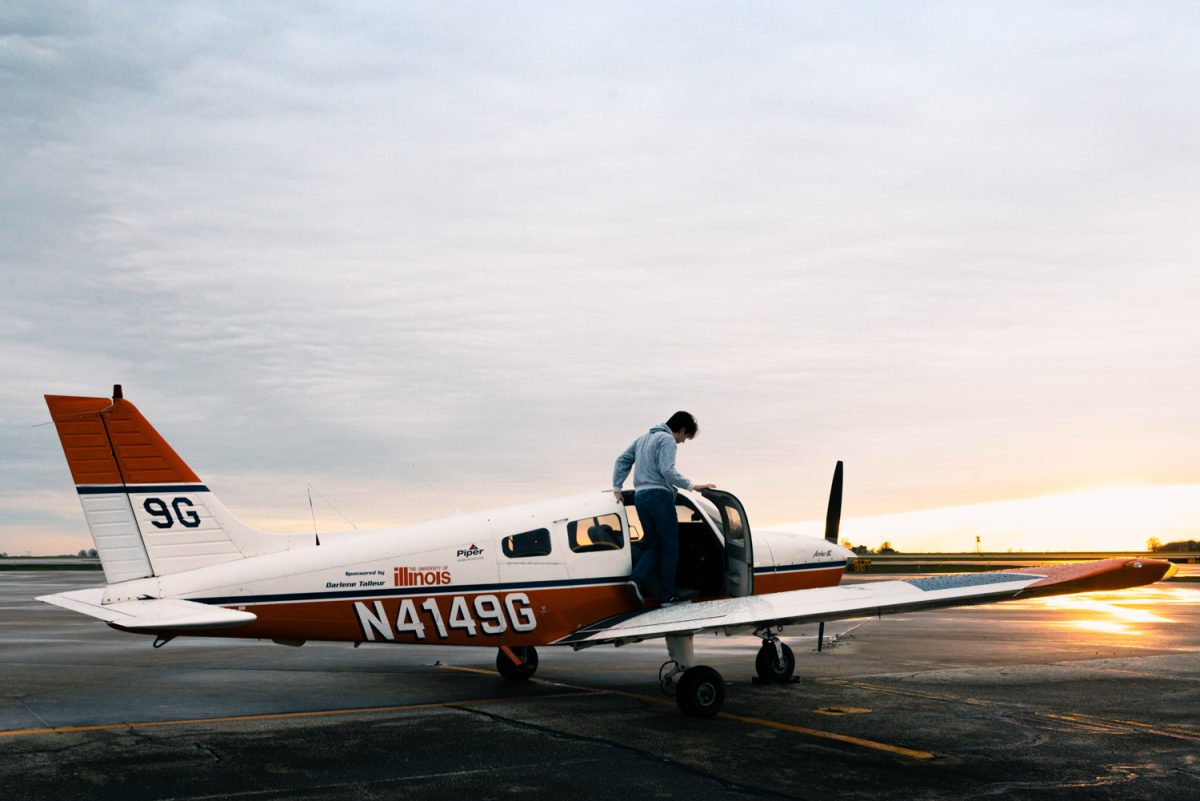 Will Kyriazakos, student pilot at Parkland College, jumps into an aircraft on a ramp on April 3.