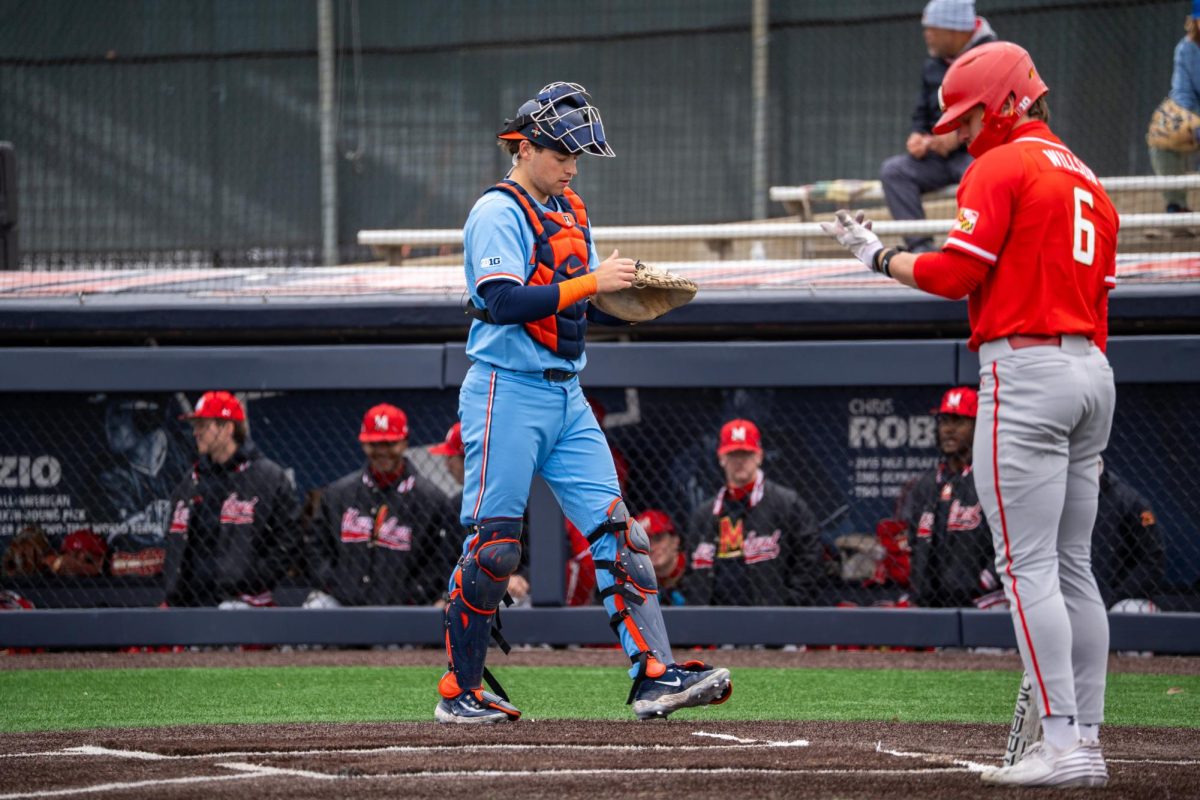 Graduate student catcher Jacob Schroeder walks back to his post behind home plate against Maryland on April 6.