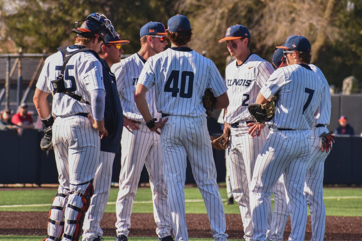 The Illini gather for a mound visit during their game against the Indiana Hoosiers on April 12.
