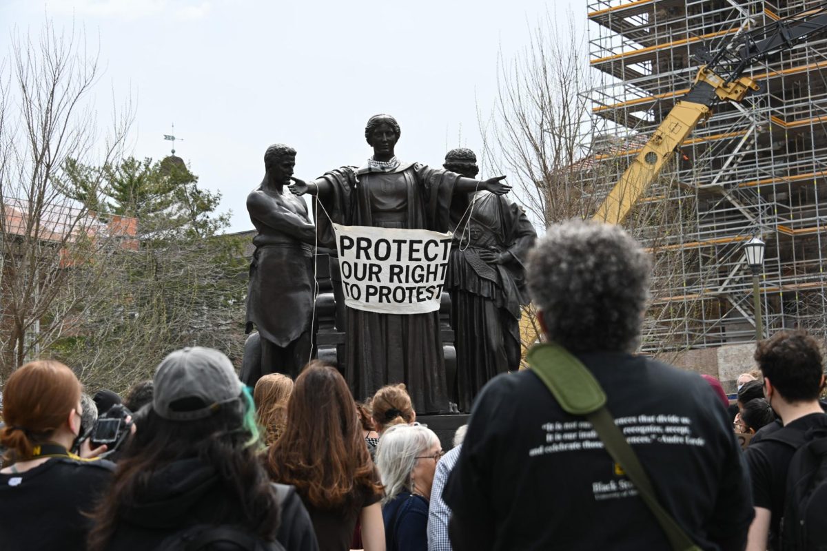 Community members protest the University’s recently revised policies on expression and demonstrations at Alma Mater on Friday.