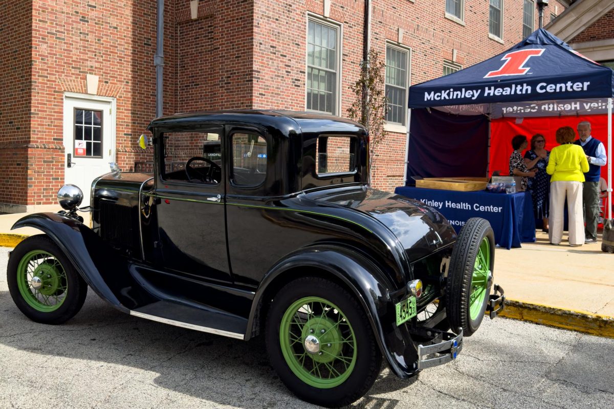 An early 1900s car sits parked in front of a McKinley Health Center tent on Thursday. 