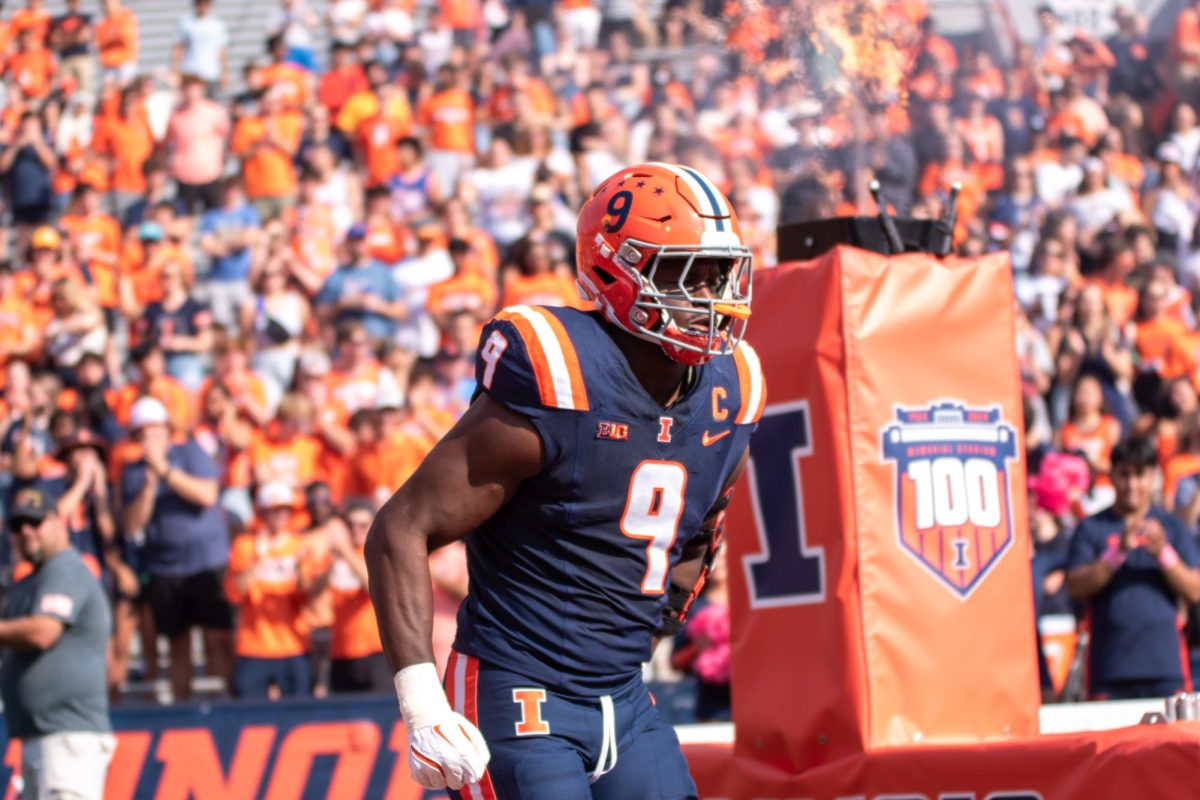 Linebacker Seth Coleman runs out from the tunnel before a game against Purdue on Oct. 12, 2024.