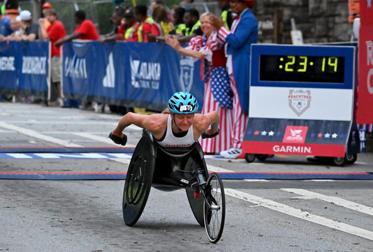 Susannah Scaroni crosses the finish line winning the women’s wheelchair division during the 2023 Atlanta Journal-Constitution Peachtree Road Race, July 4, 2023, in Atlanta. 