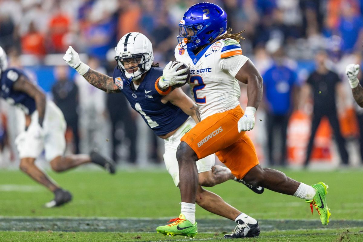 Boise State running back Ashton Jeanty runs as Penn State safety Jaylen Reed chases during the fourth quarter of the Fiesta Bowl on Dec. 31, 2024.