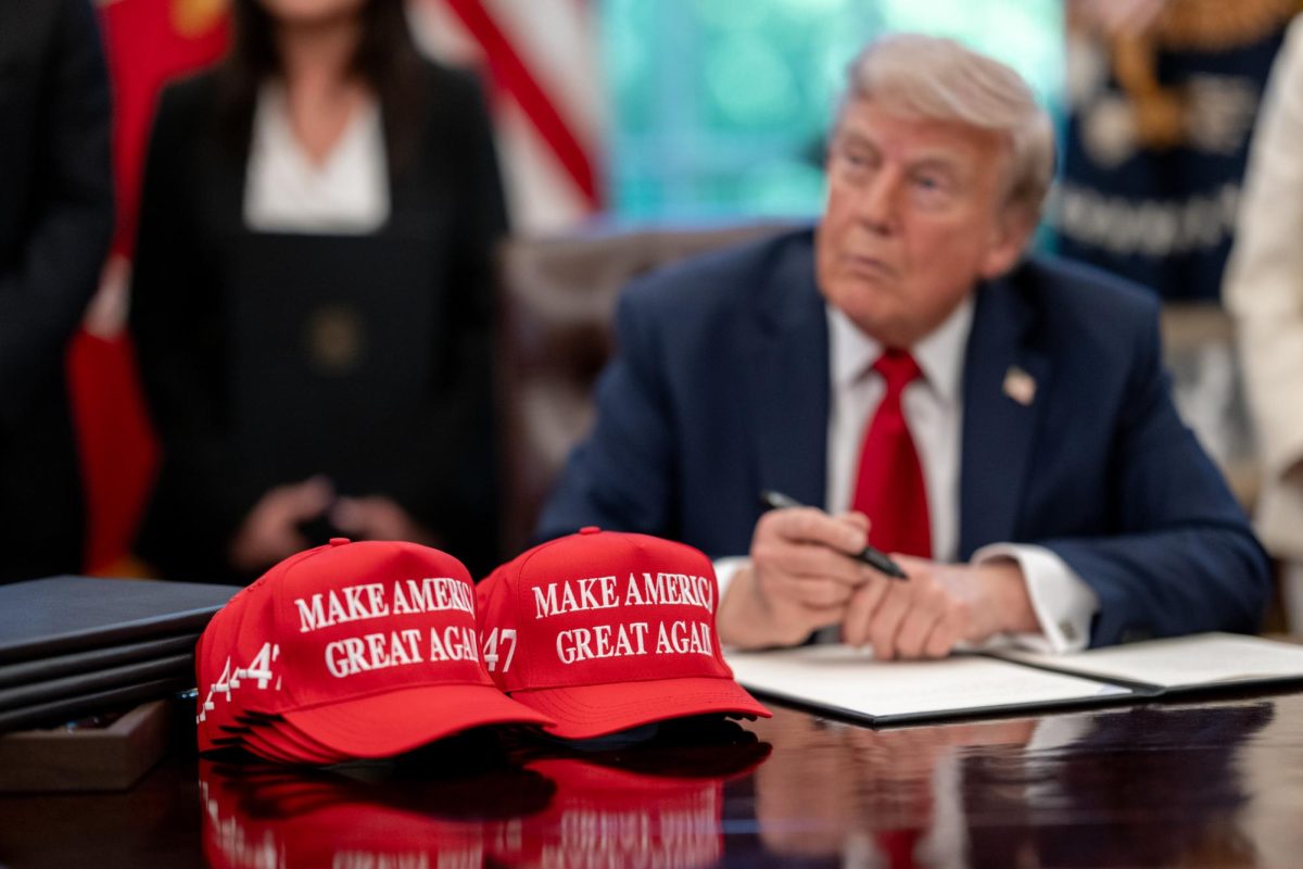 President Donald Trump signs executive orders in the Oval Office on Wednesday.