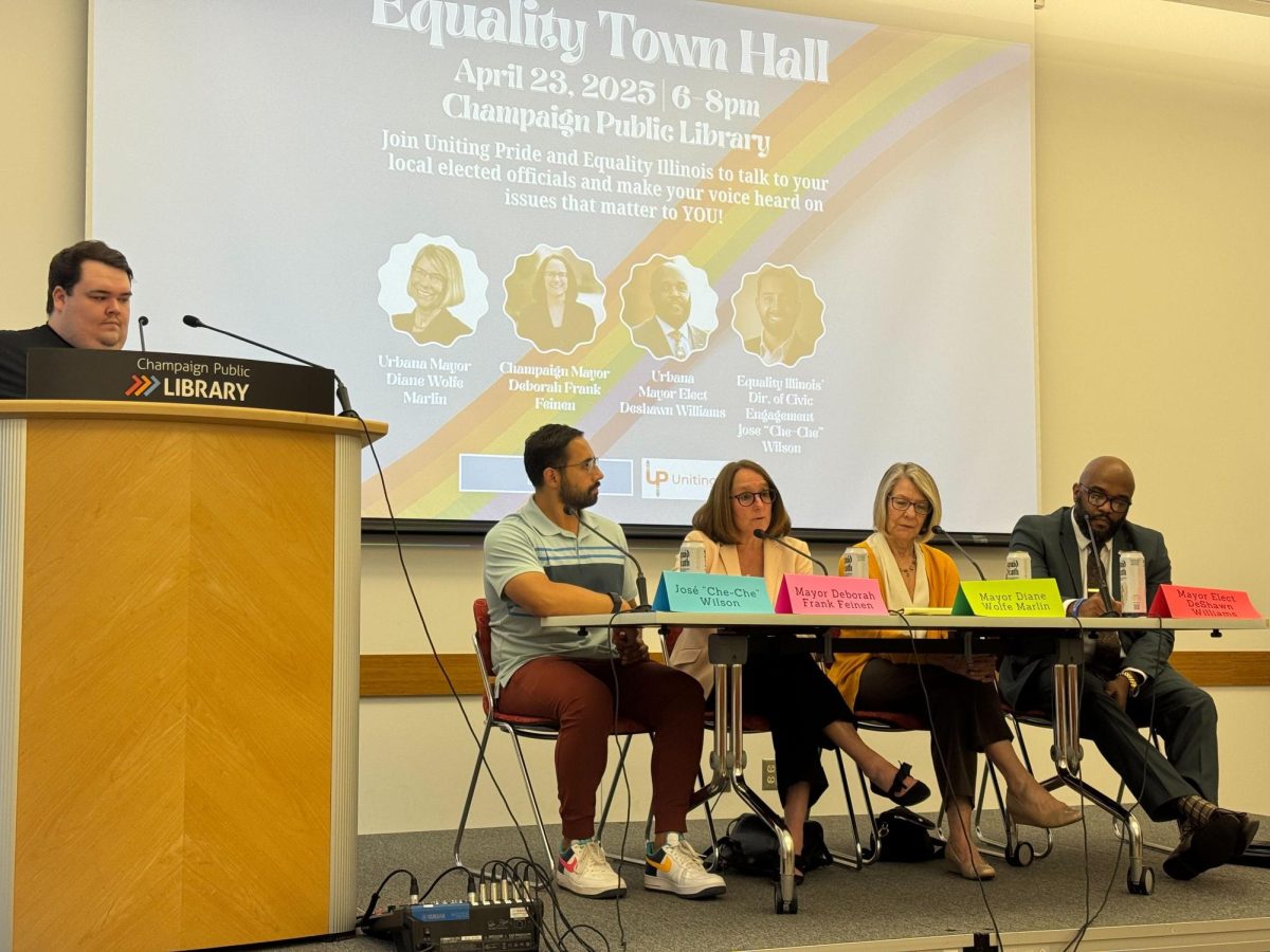 Interim Executive Director of Uniting Pride Joshua Gavel, Equality Illinois Director of Civic Engagement Jose Wilson, Champaign Mayor Deborah Frank Feinen, Urbana Mayor Diane Wolfe Marlin and Urbana Mayor-elect DeShawn Williams at Wednesdayʼs town hall. The panel answered questions from community members and spoke on issues pertinent to the LGBTQ+ community.