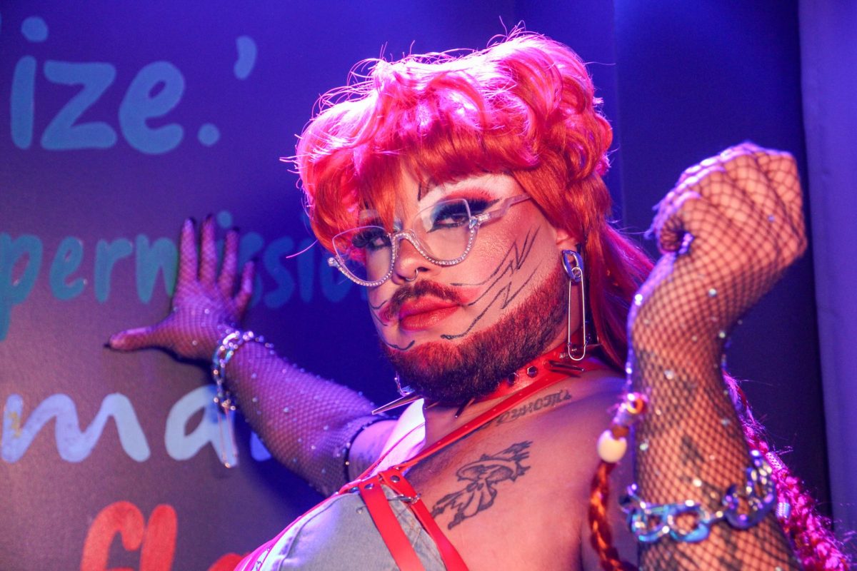 Herra Win, a local drag queen from Danville, Ill., poses before a comedy show at The Space on E. Main Street on March 27.