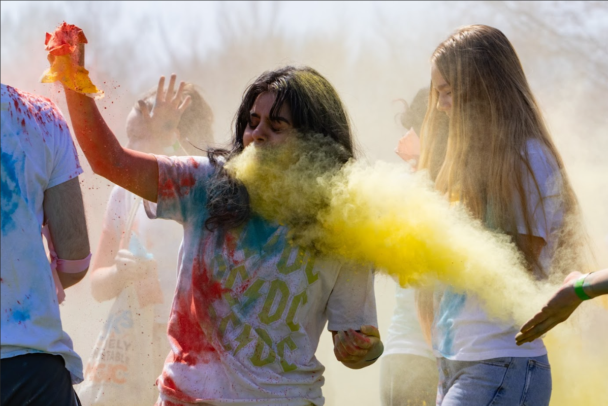 An attendee is hit with colored powder during the Holi celebration hosted by the Asha for Education UIUC club on April 12.