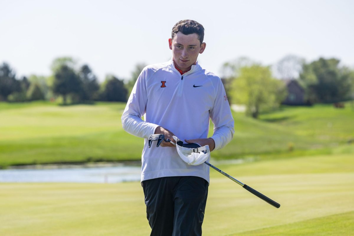 Junior Ryan Voois smiles as he walks with his putter at the Illini Spring Collegiate on April 21, 2024.