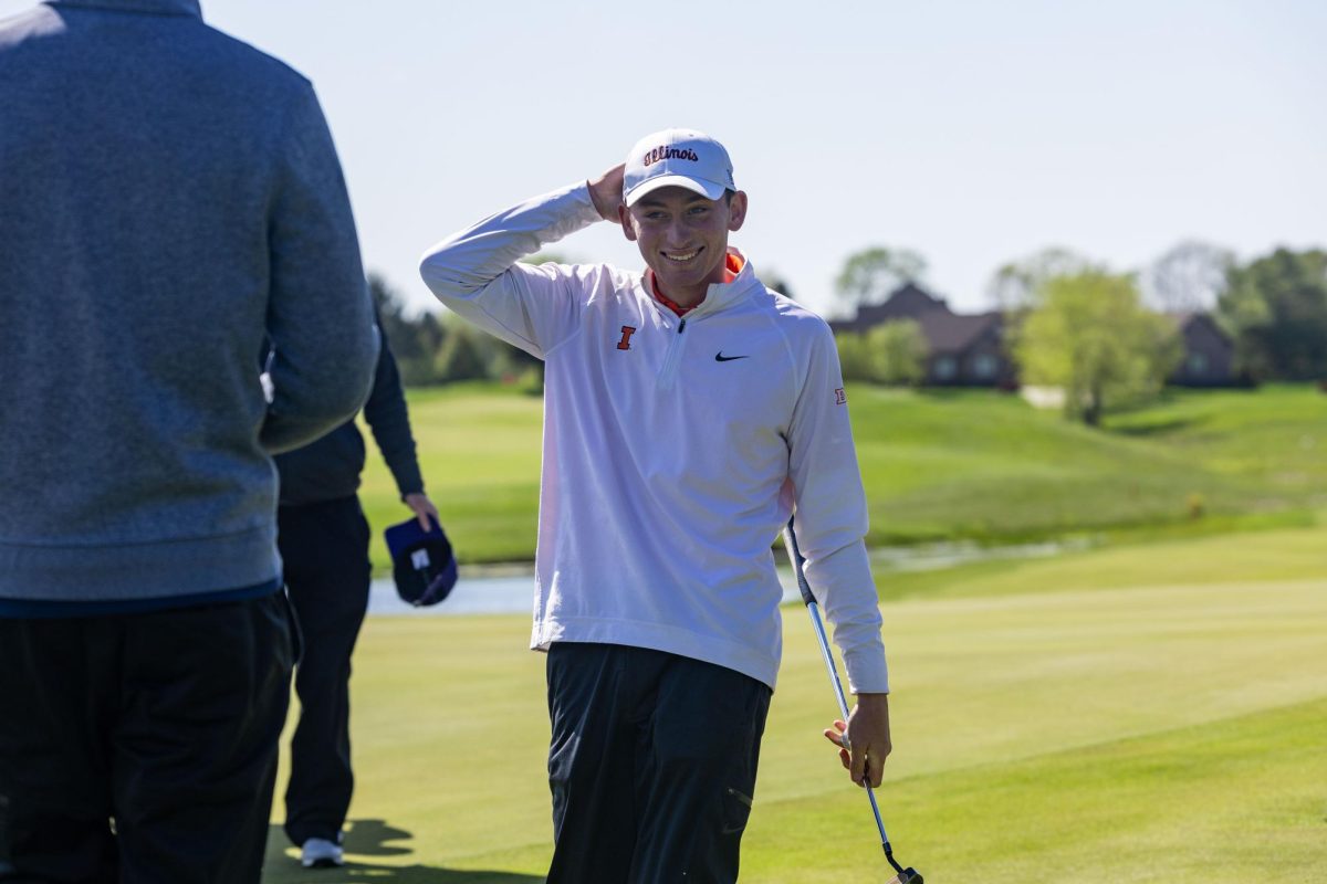 Junior Ryan Voois smiles, walking with his putter at the Illini Spring Collegiate on April 21, 2024.