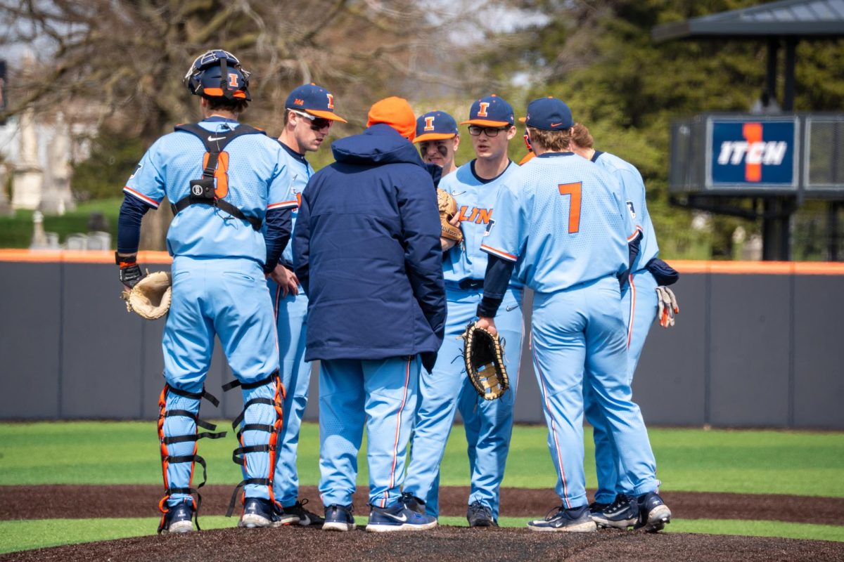 The Illini gather during a mound visit against Maryland on April 6.