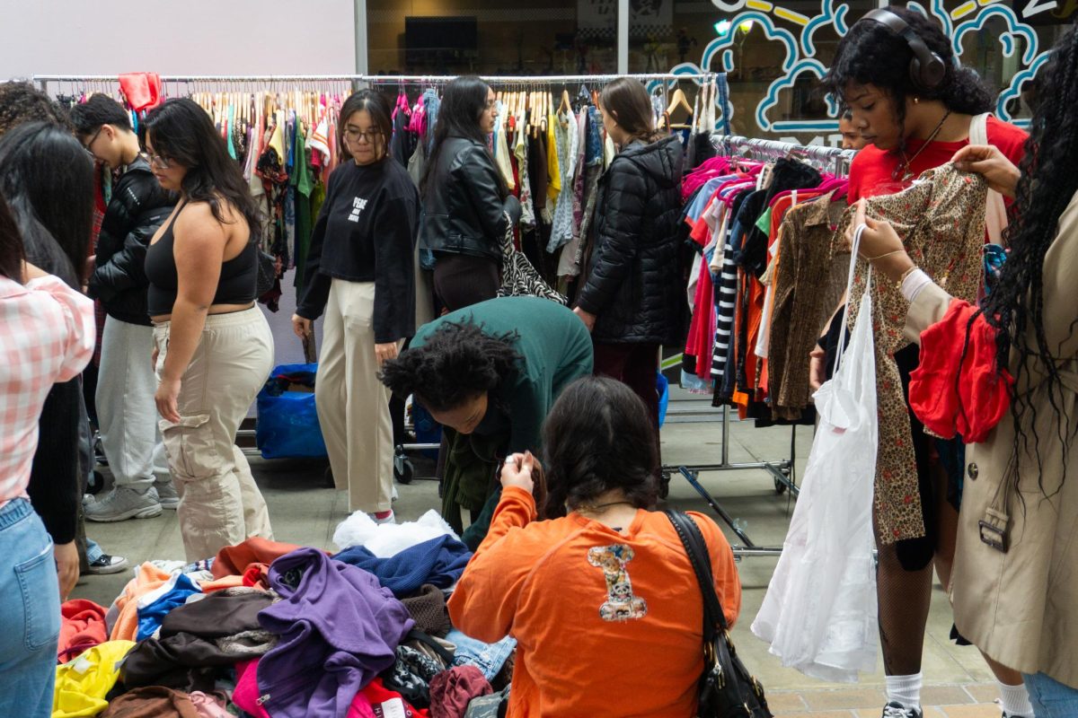 Customers look through piles of clothing at the Illinois Vintage Fest on April 19 at the Lincoln Square Mall in Urbana. The event had more than 50 vendors.