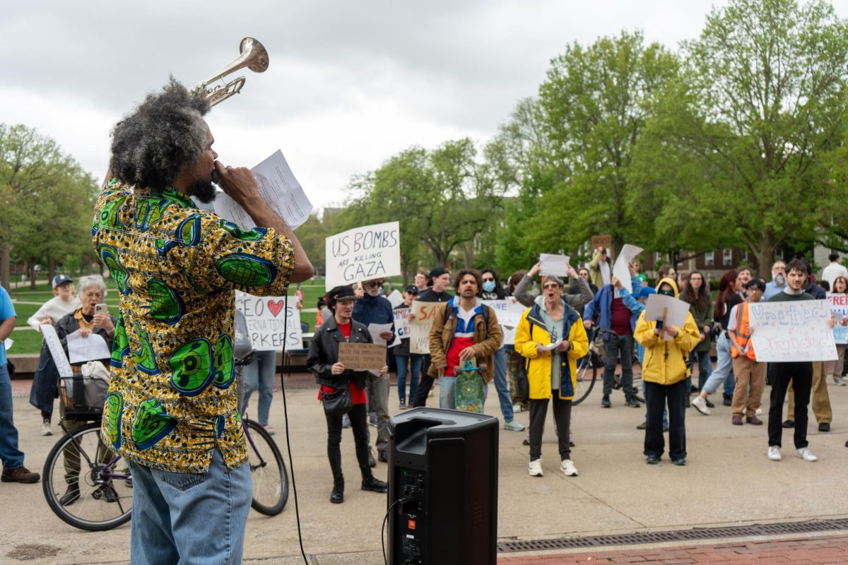 A speaker addresses the crowd during the workers’ rights rally in Anniversary Plaza on Thursday.