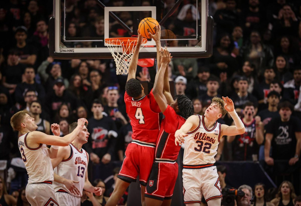 Rutgers Scarlet Knights guard Ace Bailey (4) and forward Dylan Grant (9) secure an offensive rebound over Illinois Fighting Illini guard Kasparas Jakučionis (32) on Feb. 5.