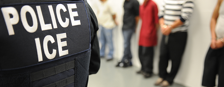 An ICE officer oversees an immigration enforcement operation on June 11, 2019. 