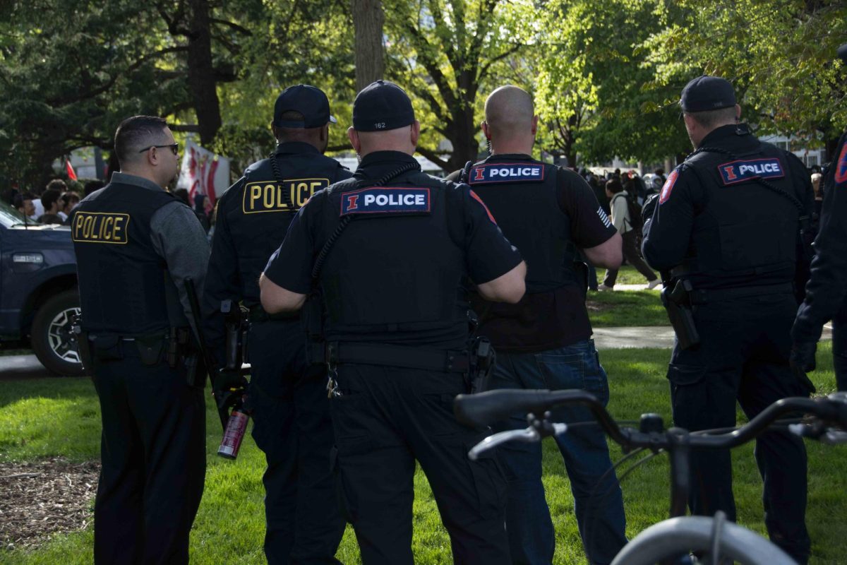 Campus and community police officers stand together at a protest in April 2024, prior to the 2025-26 budget debate.