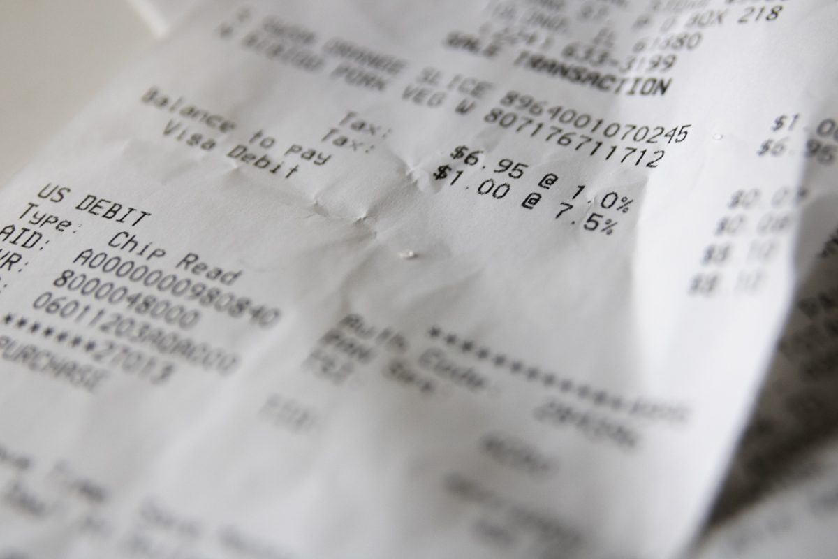 A receipt displays Illinois taxes, including the one percent grocery tax. The tax will be officially removed statewide on January 1, 2026, but local governments have the option to keep it.