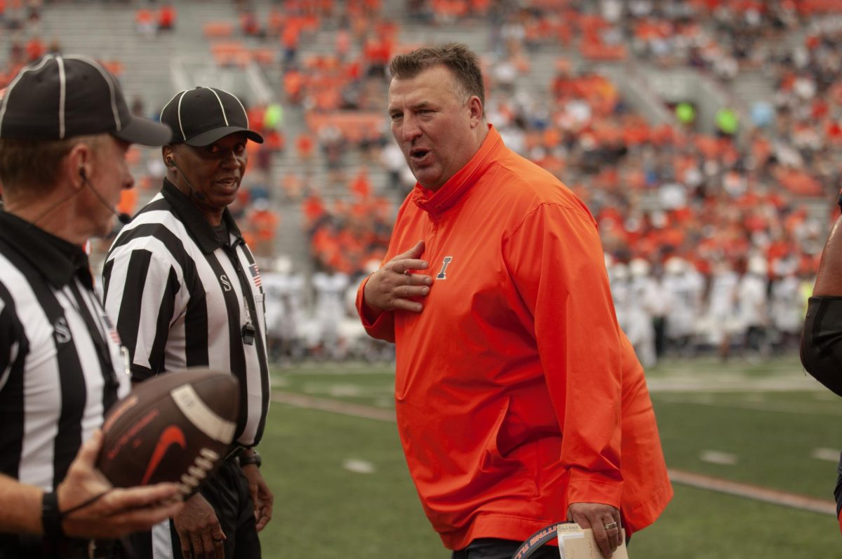 Illinois football head coach Bret Bielema  talks to a referee at a game against Penn State on September 16, 2023.