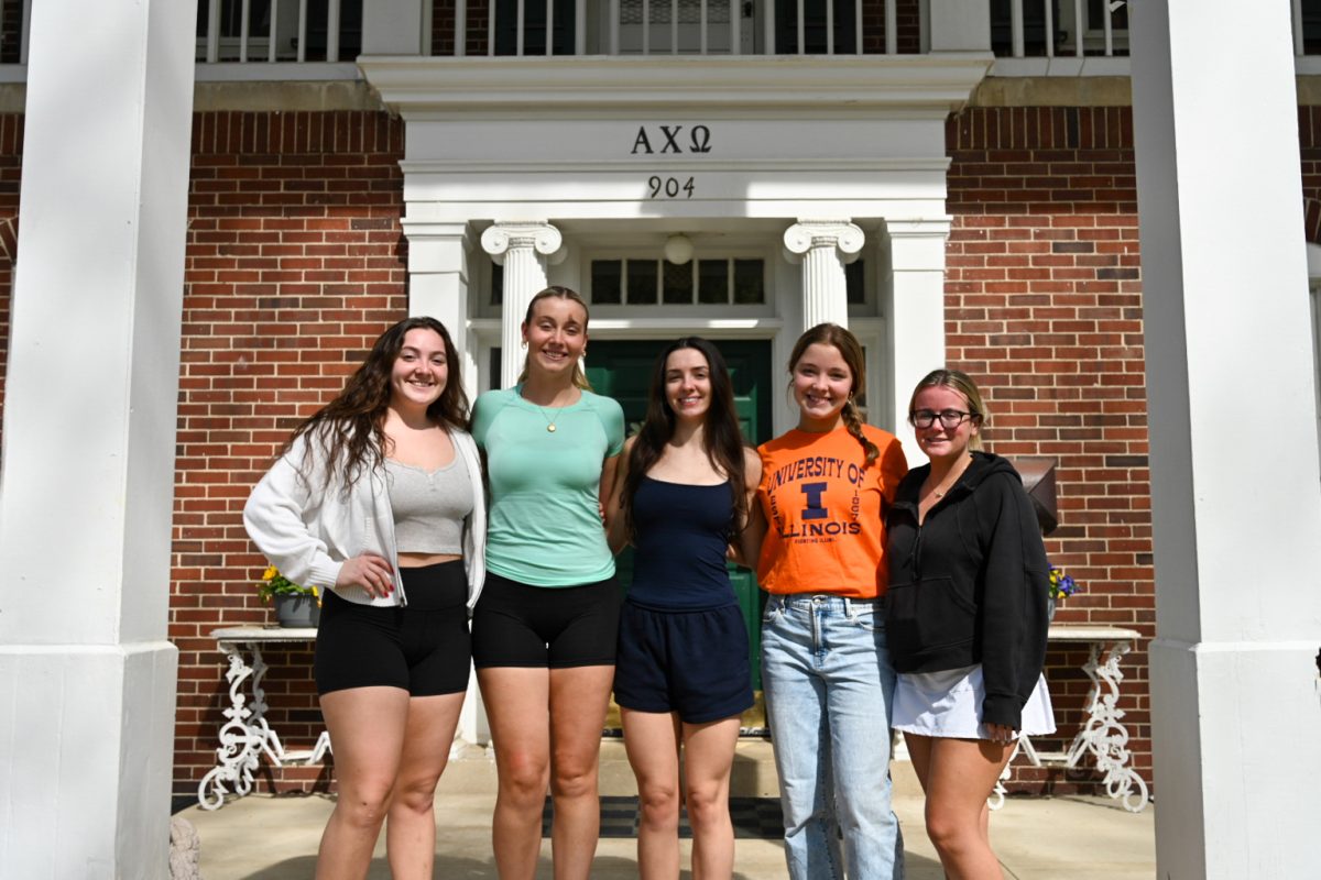 Members of Alpha Chi Omega stand outside their sorority house. Alpha Chi Omega is one of 90 sororities and fraternities on campus.