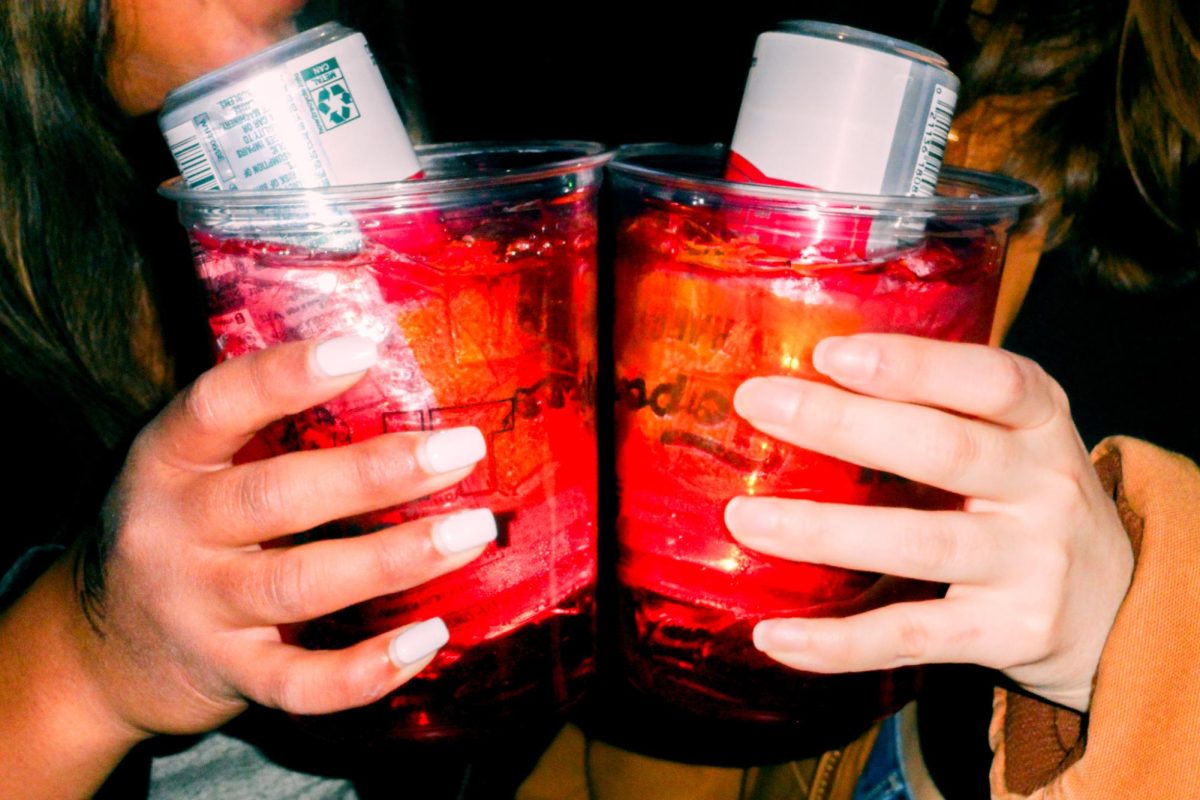 Friends salute their F*** It Buckets in honor of making it out to happy hour at the Red Lion on Feb. 14.