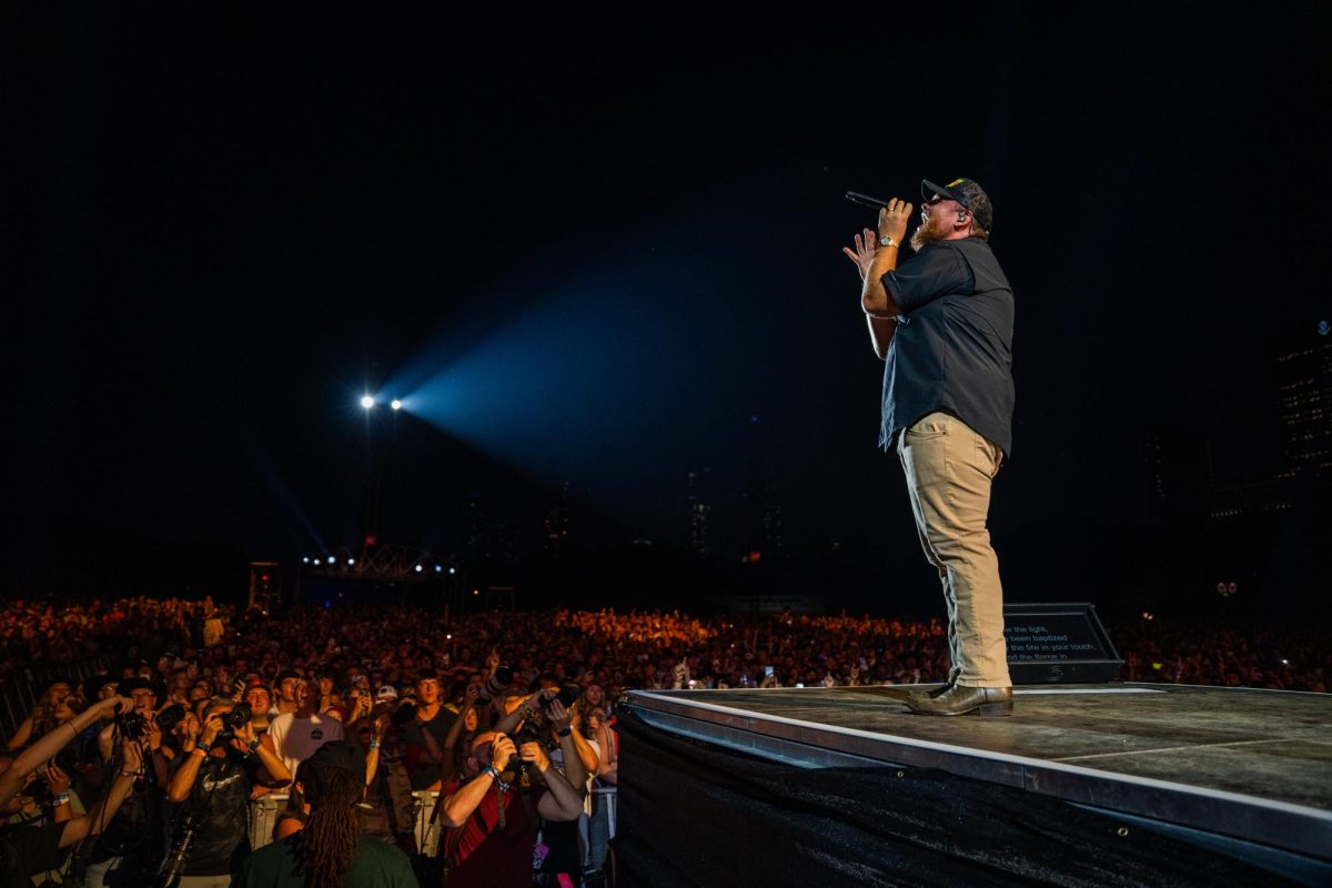 Luke Combs stands on the edge of the Bud Light Stage and sings to an adoring crowd on the first day of Lollapalooza, July 31.