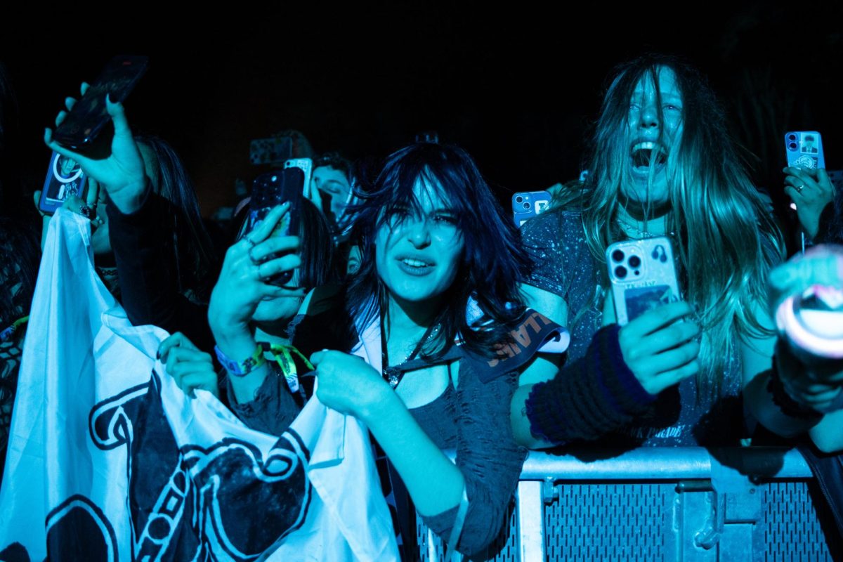 The crowd erupts with cheers as the band members play.