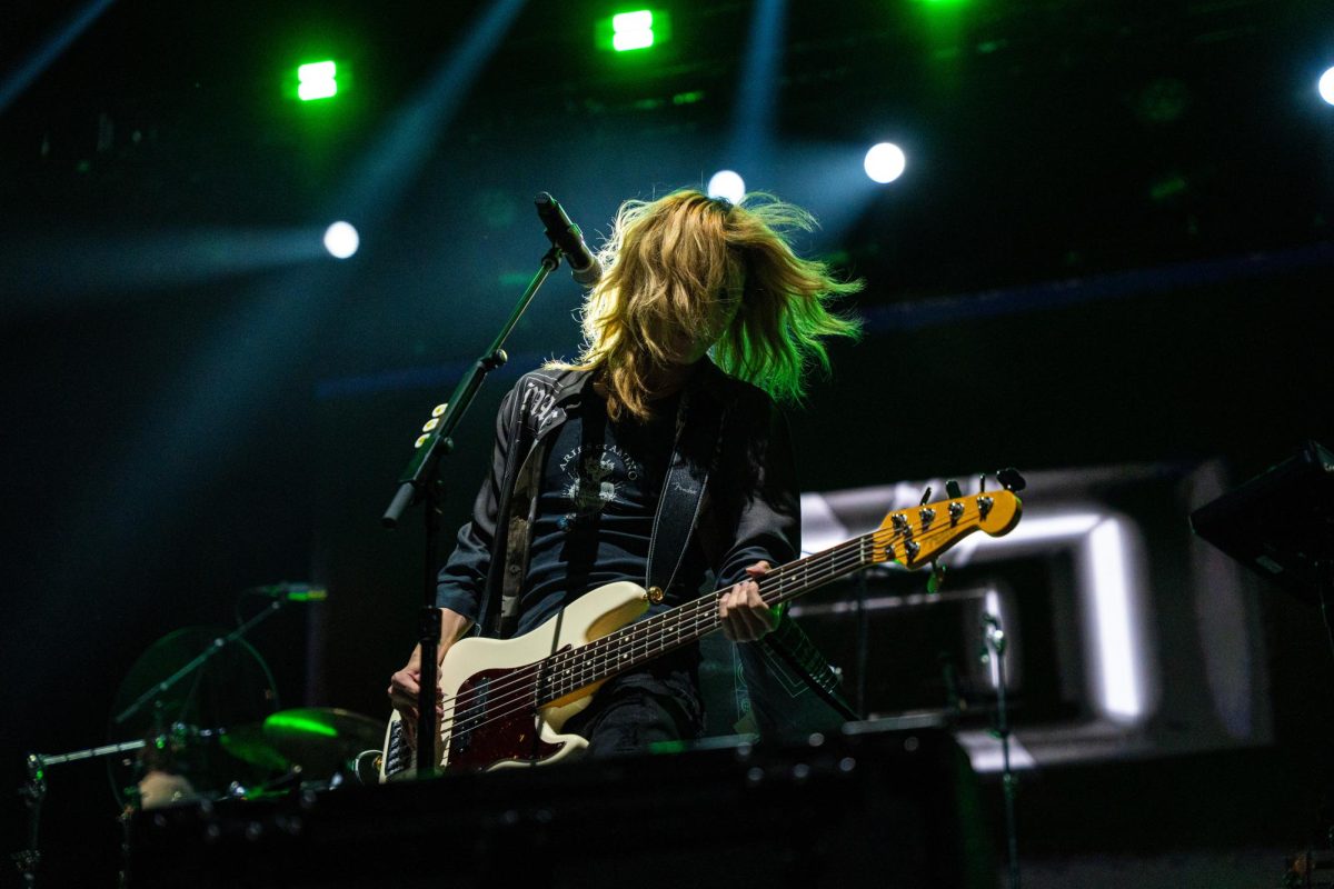 Jooyeon, bassist of the South Korean rock band "Xdinary Heroes," jams out on stage to close out the first night of Lollapalooza, July 31.