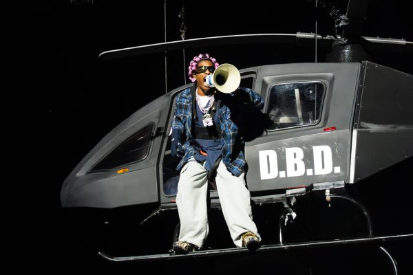 A$AP Rocky stands on the landing gear of a helicopter prop at the beginning of his set on the Bud Light stage to close out day 4 of Lollapalooza. The performance featured multiple props including the helicopter, metal detectors, flame cannons and his megaphone microphone.