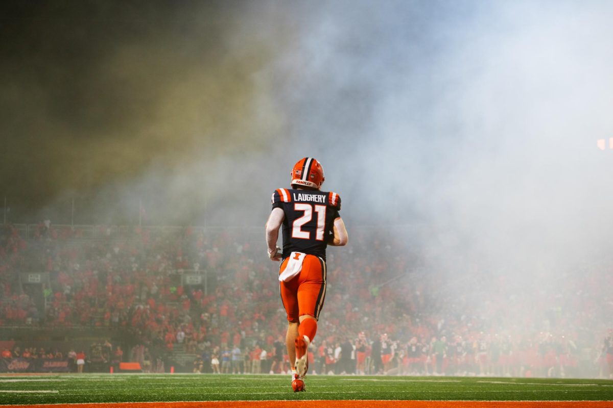 Running back Aidan Laughery runs onto the field before the Illinois vs. Eastern Illinois game on Aug. 24, 2024.
