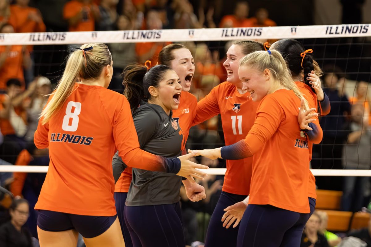 Members of the Illinois volleyball team celebrate during a match against USC on Nov. 8, 2024.