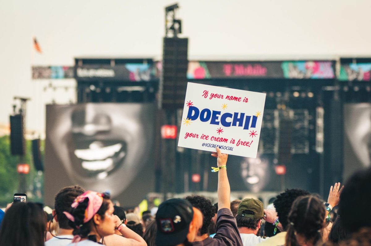 "If your name is Doechii your ice cream is free!" reads an 'Ice Cream Social' vendor sign help up from the back of T-Mobile stage as Doechii performs late Saturday evening.