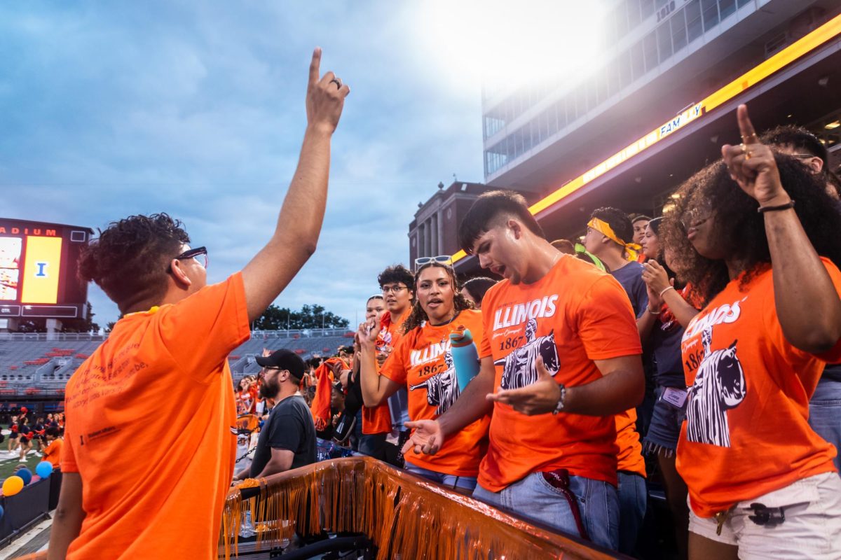 Students sing and dance as their peers stream into the stands of Memorial Stadium Thursday night for Sights and Sounds. Music, orange and blue balls, and I-L-L chants were all present as the energy was high before the event.
