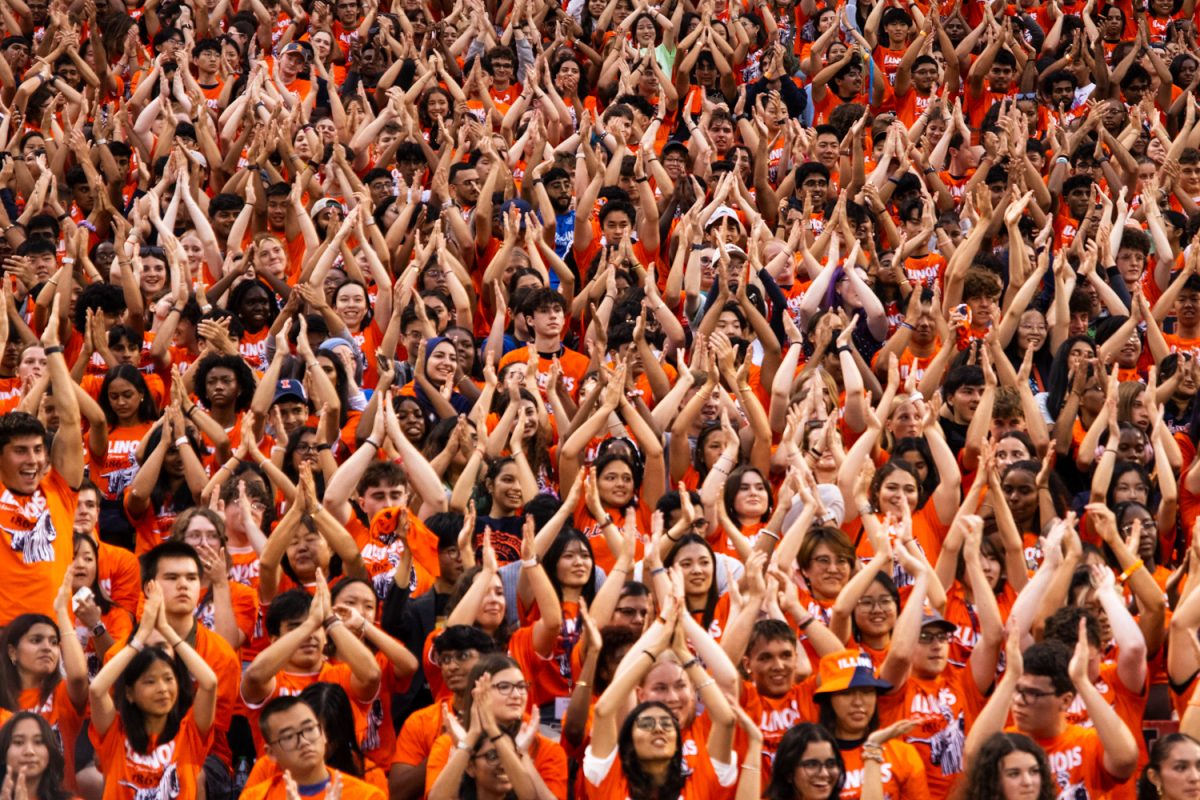 New students practice an Illinois volleyball chant and clap their hands together along with the team at the 2025 Sights & Sounds in Memorial Stadium. This year, the University welcomed more than 9,200 freshmen. 