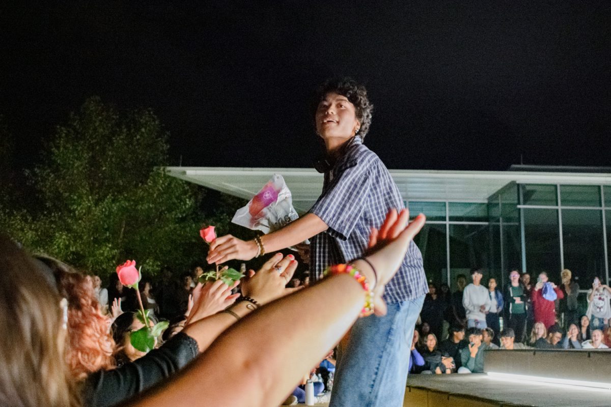 A contestant in the Most Performative Male Contest hands out flowers to the front row of the audience on Sept. 6, 2024.