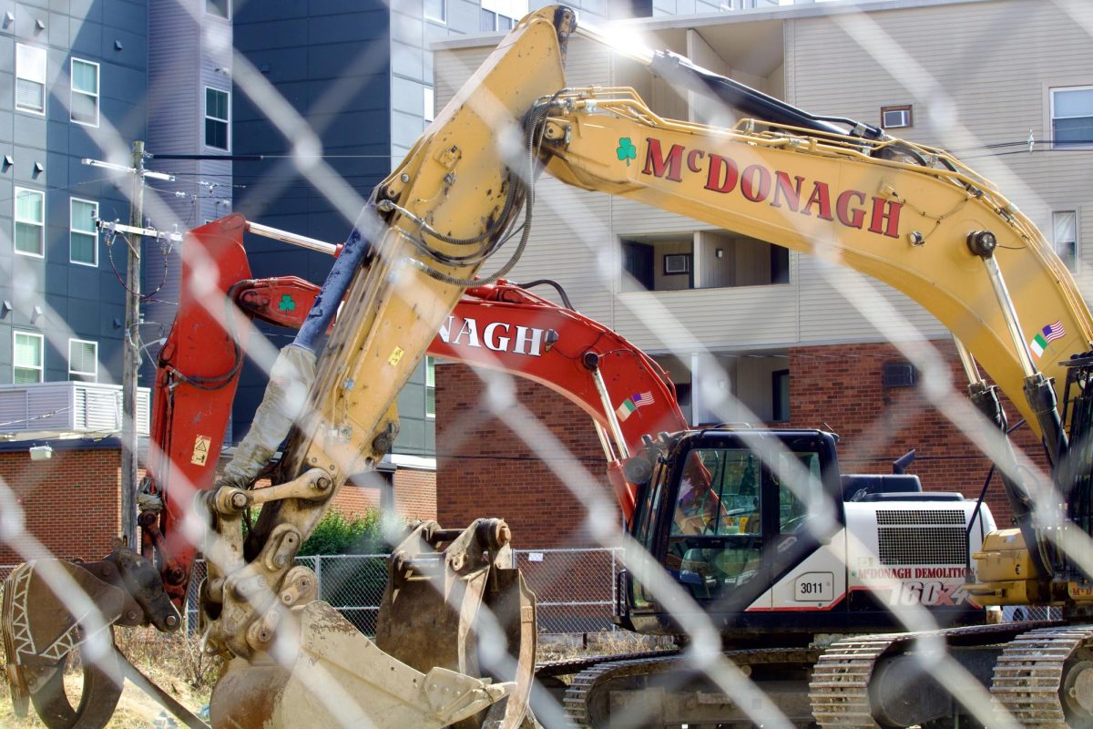 Empty construction lots, closed off by metal gates and older apartment buildings under halted renovation line Green St. in Champaign on Sept. 13. 