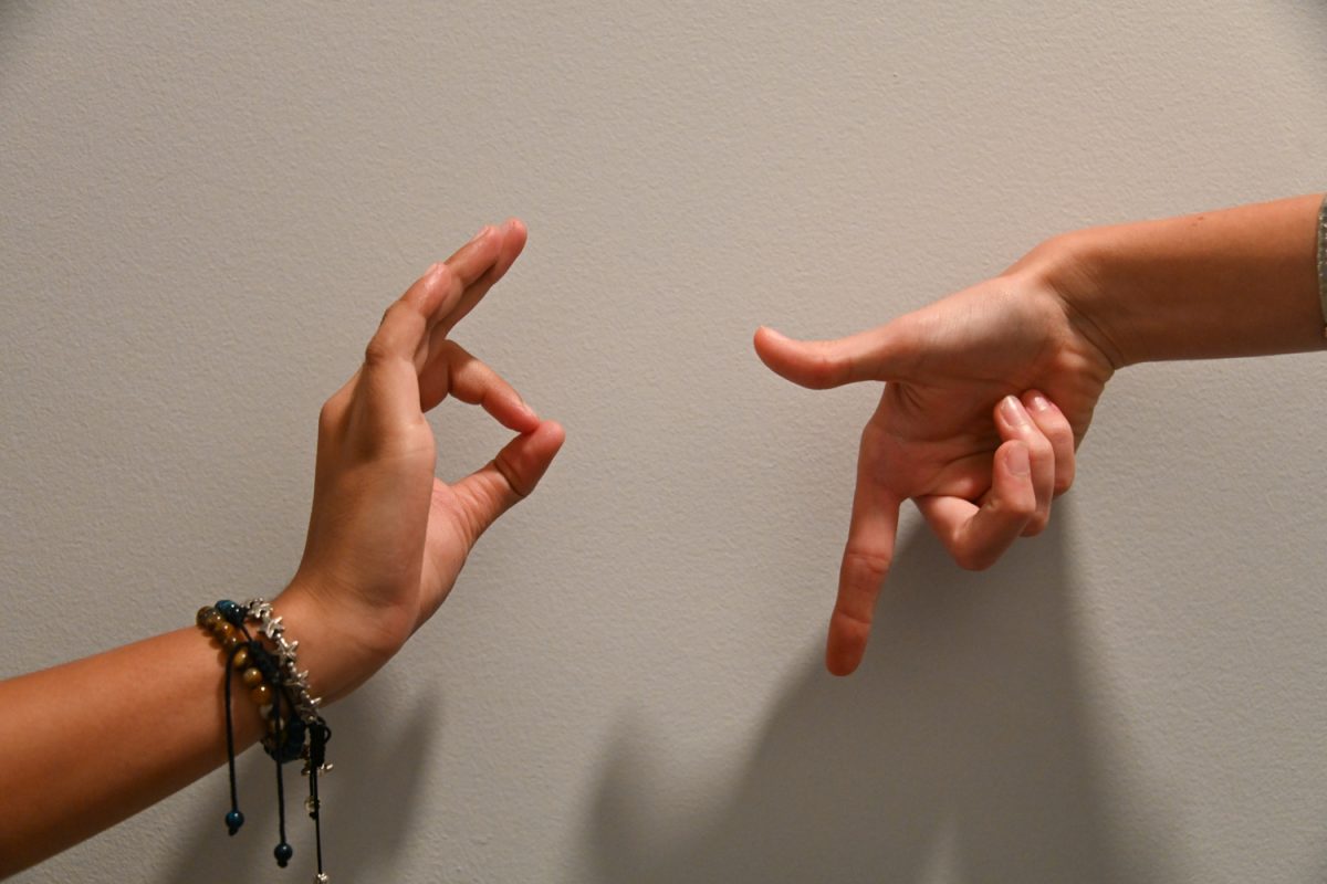 Hands make the numbers six and seven in the air. Columnist Alexander Fako writes about how slang terms inhabit popular vernacular over time, especially after widespread usage on the internet.