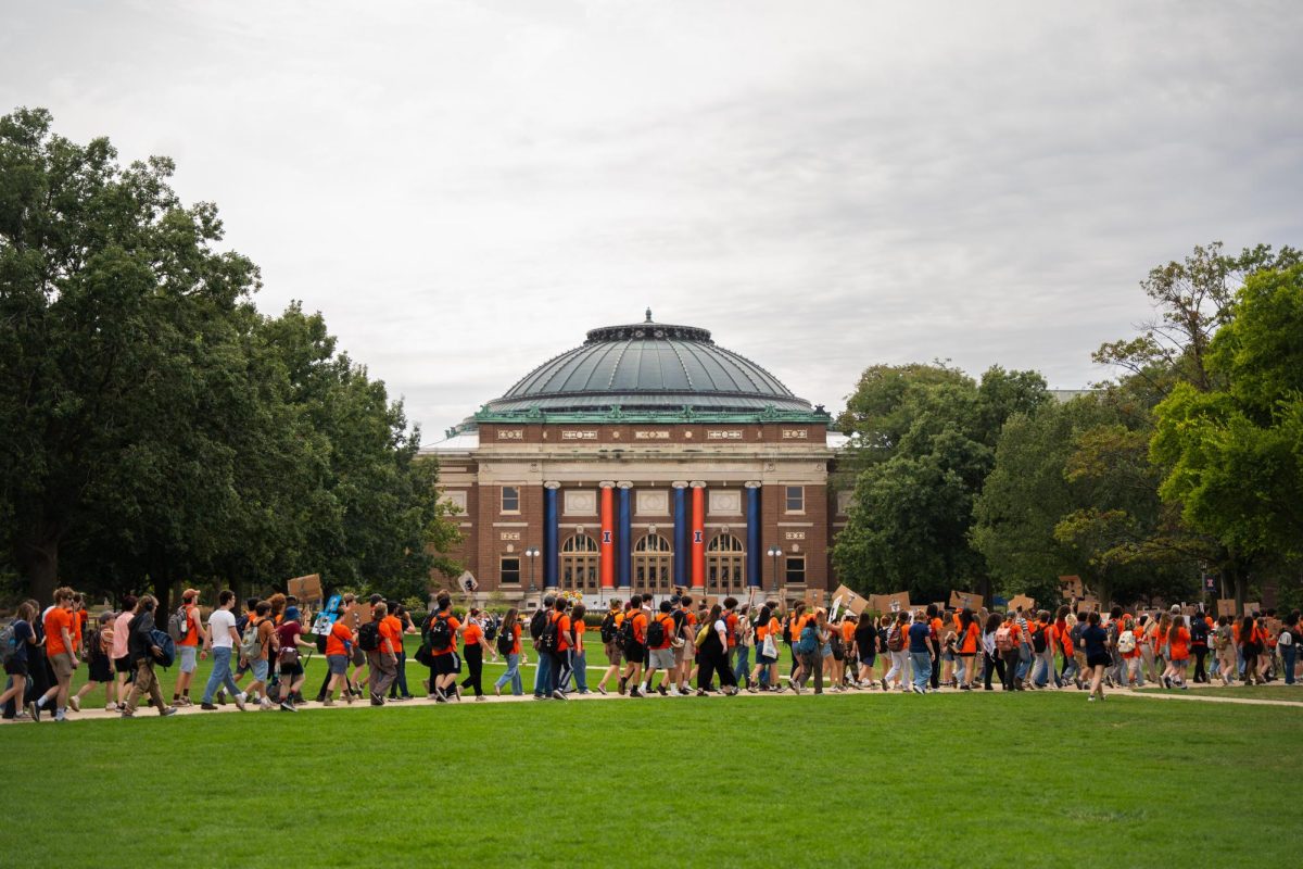The "March for our Climate" passes through the main quad in front of Foellinger Auditorium on Friday.