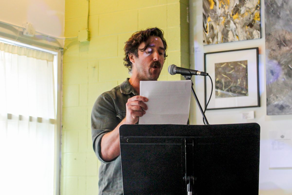 Author Kyle Seibel reads a short story at the PYGMALION Literary Event at the Gallery Art Bar in Urbana on Sept 20.