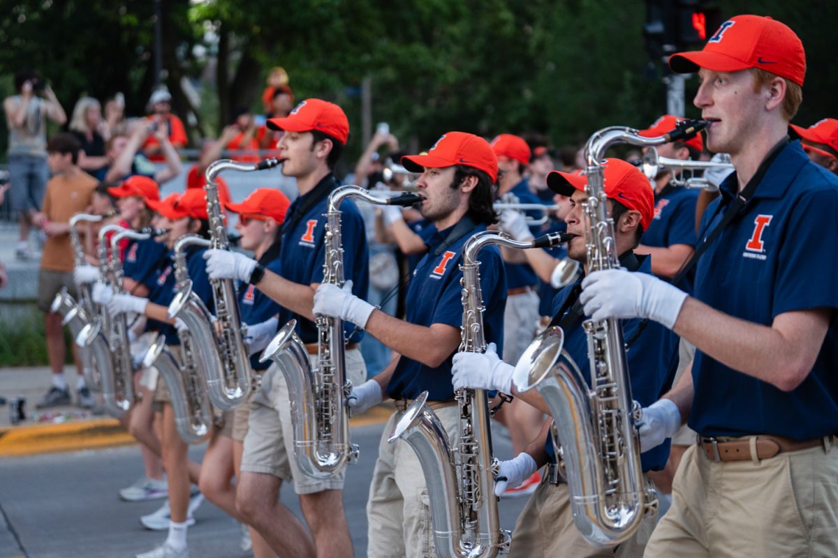 Marching Illini saxophone players serenade the crowd at the Illinois Homecoming parade. (Cori Sebastian)